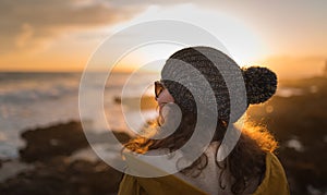 Young woman posing in front of sunset in Italy, Travel concept