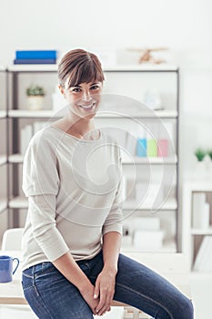 Young woman posing in her office