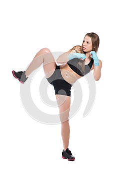 Young woman posing and kicking