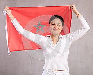 Young woman posing in studio with Morocco flag