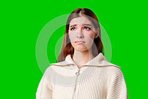 Young Woman Posing in Stylish Crop Hoodie and Pleated Skirt Against Green Screen