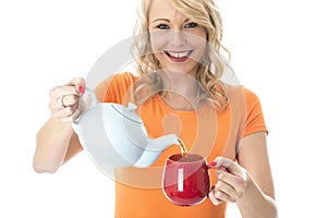 Young Woman Pouring Tea from a Teapot