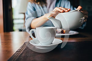 Young woman pouring tea