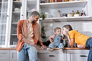 Young woman pouting lips near son