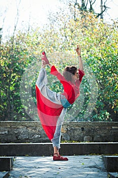 Young woman practice yoga outdoor autumn day lord of dance pose