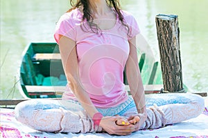 Young woman practice yoga outdoor by the lake healthy lifestyle concept