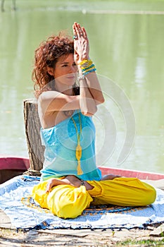 Young woman practice yoga outdoor by the lake healthy lifestyle concept  full body shot