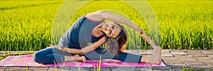 Young woman practice yoga outdoor in rice fields in the morning during wellness retreat in Bali BANNER, LONG FORMAT