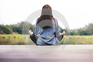 Young Woman Practices Yoga in Outdoor. Sitting in Lotus Position. Unplugged Life and Mental Health Concept