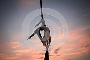 Young woman practicing aerial sylks