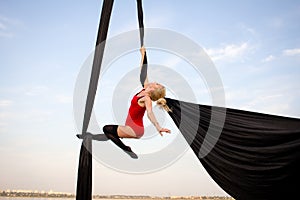 Young woman practicing aerial sylks