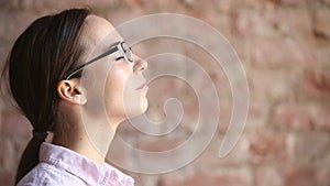 Young woman practicing breathing fresh air exercises, taking deep breath