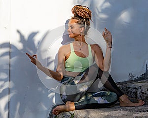 Young woman practicing Purna Matsyendrasana, Full Spinal Twist pose. Flexible spine. Hands in gyan mudra. Body care, healthy