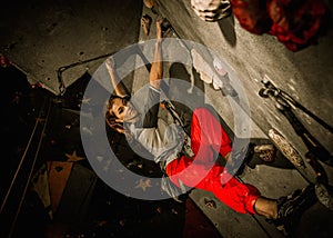 Young woman practicing rock-climbing