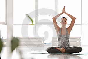 Young woman practicing yoga. Accomplished pose Siddhasana