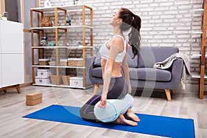 Young Woman Practicing Yoga With Bolster photo