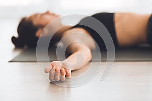 Young woman practicing yoga in corps pose