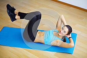 Young woman practicing yoga, doing Wild Thing, Flip-the-Dog exercise, Camatkarasana pose, working out, wearing sportswear, black