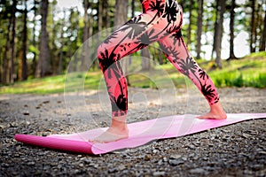 Young woman practicing yoga in a forest. Mindfulness concept. Meditation, relax, mind and body