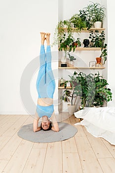 Young woman practicing yoga indoor.
