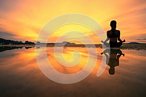 Young woman practicing yoga in the nature, Female happiness, Silhouette of young woman practicing yoga on the beach at sunset photo