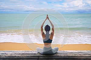 Young woman practicing yoga in the nature, Female happiness, Young healthy woman practicing yoga on the beach at sunset