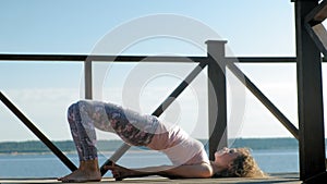 Young woman practicing yoga outdoors in summer. Healthy lifestyle