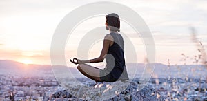 Young woman practicing yoga outdoors at sunset. Beautiful girl meditate outdoor, panoramic view.