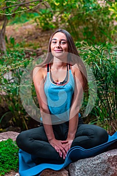Young woman practicing yoga in the parck