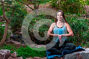 Young woman practicing yoga in the parck