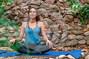 Young woman practicing yoga in the parck