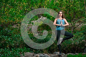 Young woman practicing yoga in the parck