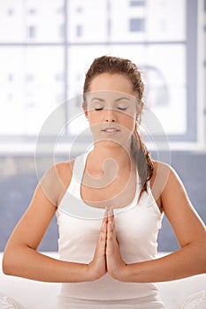 Young woman practicing yoga prayer pose