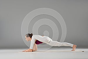 young woman practicing yoga, stretching in Lizard exercise, Utthan