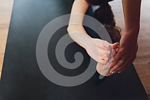 Young woman practicing yoga, stretching in variation of Reverse Table Top exercise, Bridge pose, working out, wearing