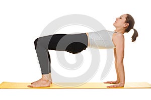 Young woman practising yoga exercises