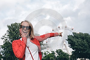 Young woman in the Prater area on the background of the Vienna Ferris Wheel