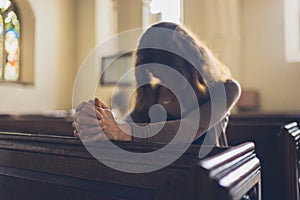 Young woman praying in church