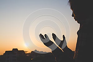 Young woman praying with hand, prayer concept for faith, spirituality and religion