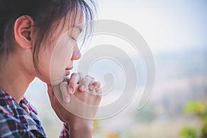 Young woman praying with  hand,  prayer concept for faith, spirituality and religion