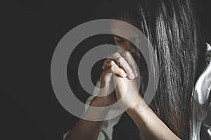 Young woman praying with  hand,  prayer concept for faith, spirituality and religion