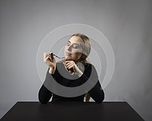 Young woman is praying with rosary beads