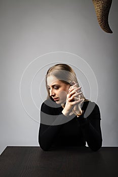 Young woman is praying with rosary beads. Prayer and temptation