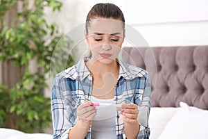 Young woman with pregnancy test. Gynecology and childbirth