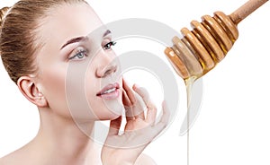 Young woman prepare for honey facial mask.