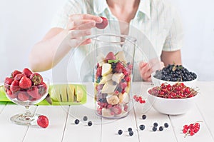 Young woman prepare to blending fruits and berries