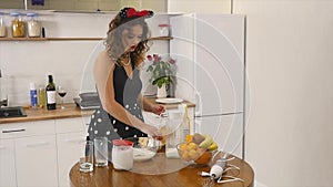 Young woman prepares dough mixing ingredients in the the bowl using whisk in the kitchen. Homemade food. Slowmotion shot