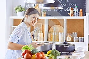 A young woman prepares food in the kitchen. Healthy food - vegetable salad. Diet. The concept of diet. Healthy lifestyle