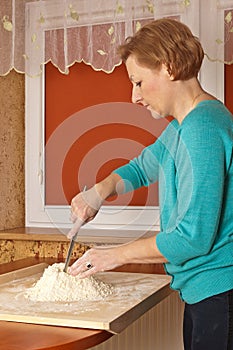 Young woman preparing dough