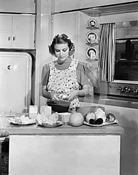 Young woman preparing food in the kitchen